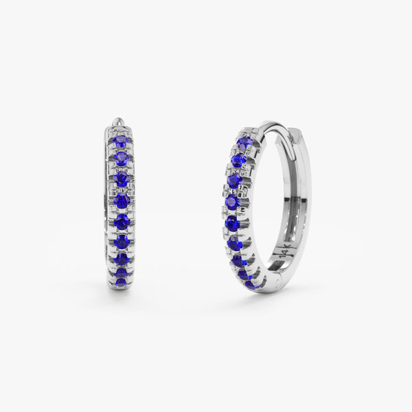 Solid 14k white gold hoop huggies with lined blue sapphires