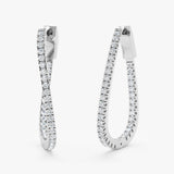 Pair of handmade 14k solid white gold wavy hoop earrings lined with natural diamonds 