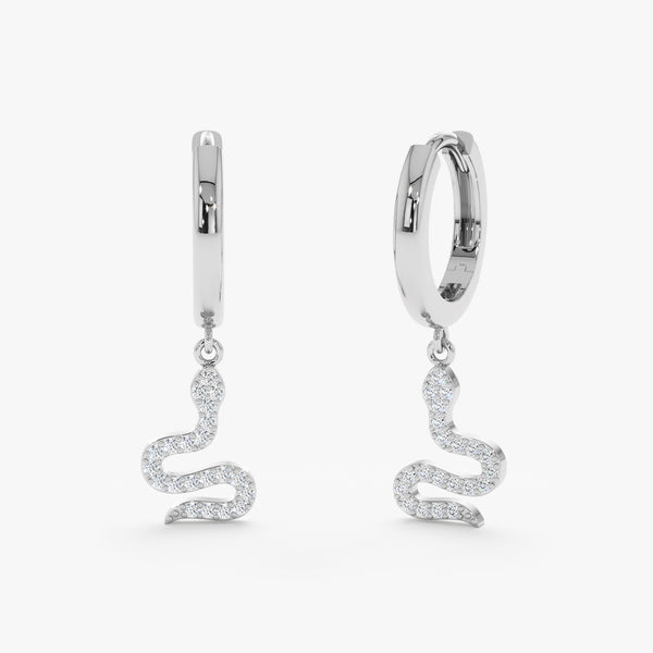 Pair of solid white gold 14k huggie earrings with diamond lined snake charm 