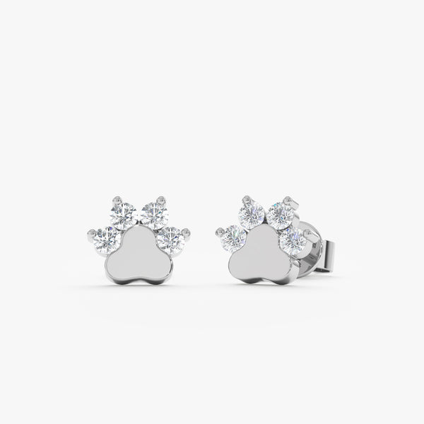 Product image of petite 14k solid white gold earring studs in dog paw shape with natural ethically sourced diamonds.