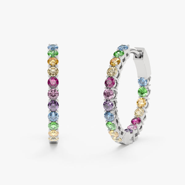 white gold huggies lined with natural rainbow sapphires