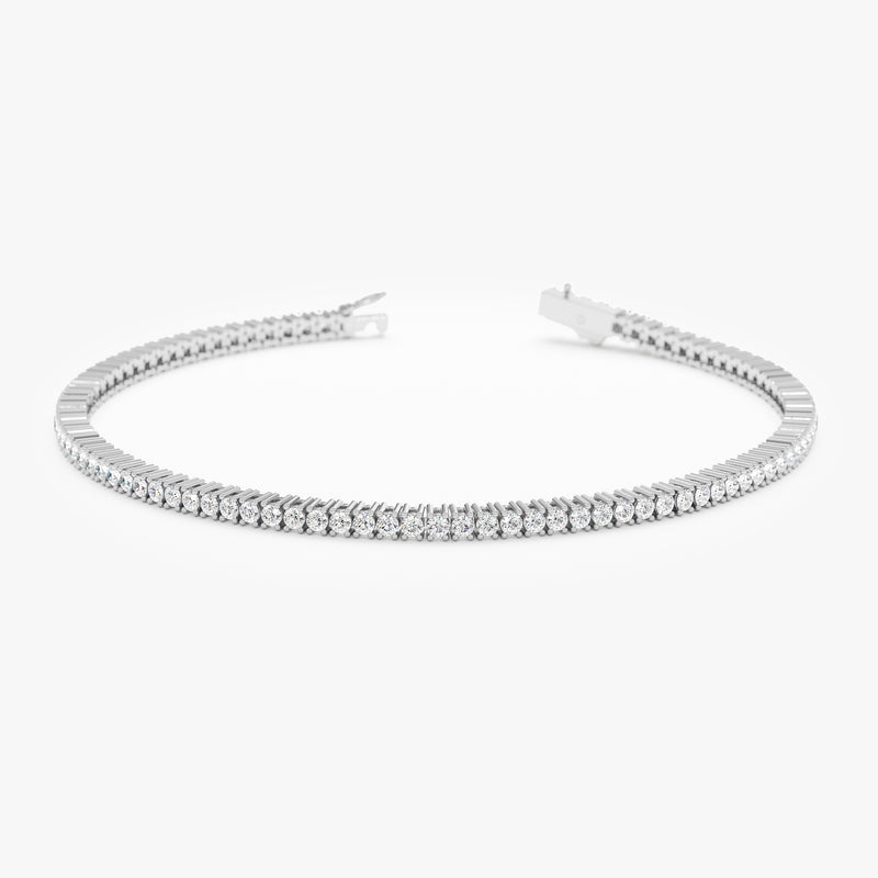 Eternal row of sparkling diamonds on a classic white gold bracelet.