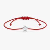 Small Gold Star Bracelet with Single Diamond on a red string, featuring a shining star charm.