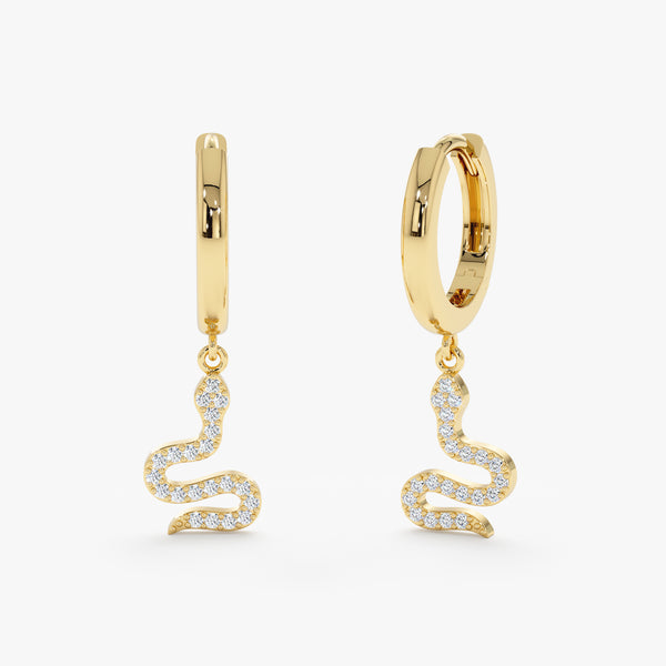 Pair of solid 14k gold huggie earrings with diamond filled snake charm 