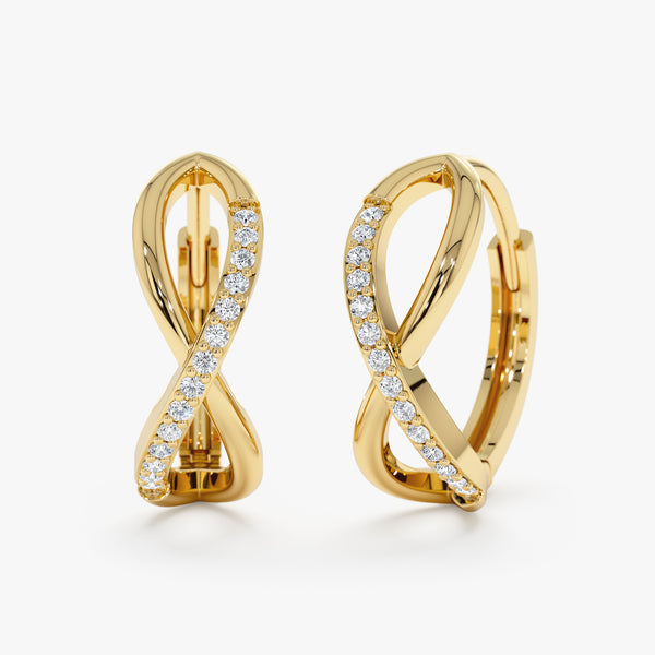 Simplistic Solid gold infinity symbol earrings with lined diamonds. 