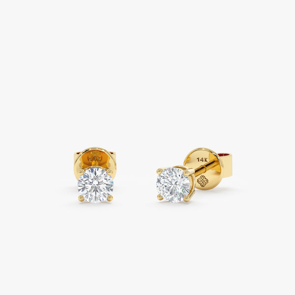Minimalist Natural diamond earring studs with 4-prong setting in solid gold.