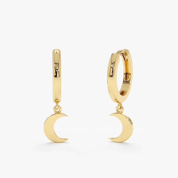 Pair of handmade crescent moon charm huggies in 14k solid gold. 