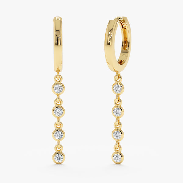 Pair of solid 14k gold drop down earrings featuring multiple white diamonds