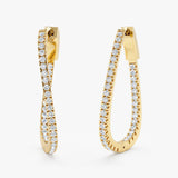 Pair of twisted hoop earrings lined in natural diamonds in 14k solid gold