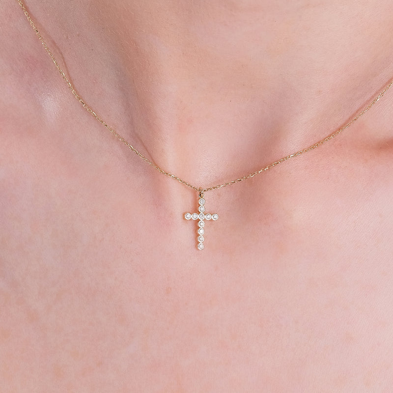 dainty diamond bezel cross pendant necklace in solid gold