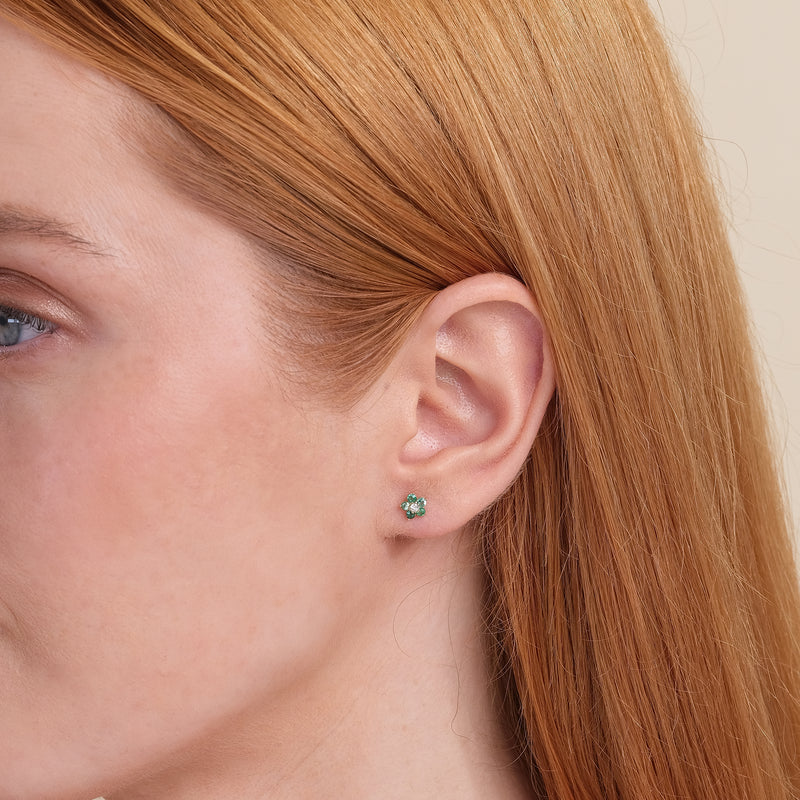 Model wears green emerald flower shape earring stud with natural April birthstone diamond gift for her. 