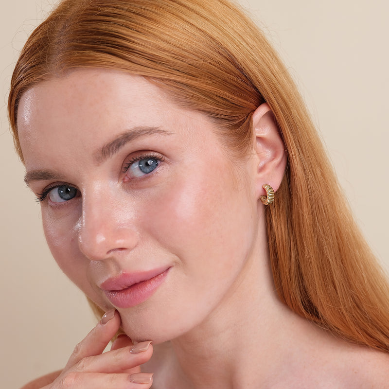 Model wears 14k solid gold thick ribbed vintage inspired earring huggie gift for her. 
