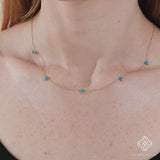 handcrafted solid gold necklace with dainty turquoise stones and diamonds