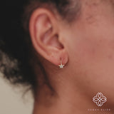 Diamond-paved star shines brightly in a 14k/18k gold huggie earring, perfect for everyday wear