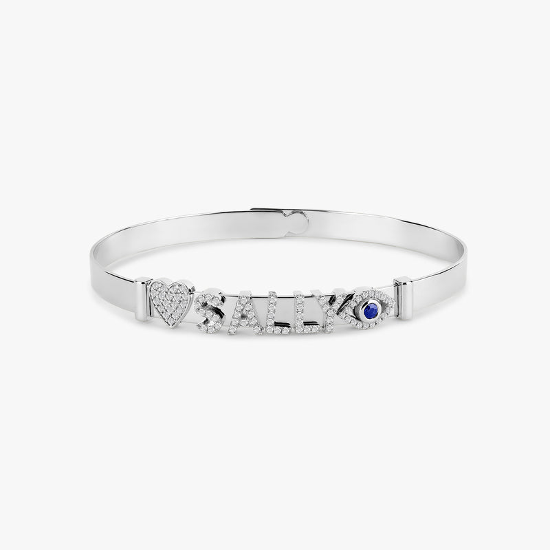 Personalizable white gold bangle with slide-on charms for unique designs.