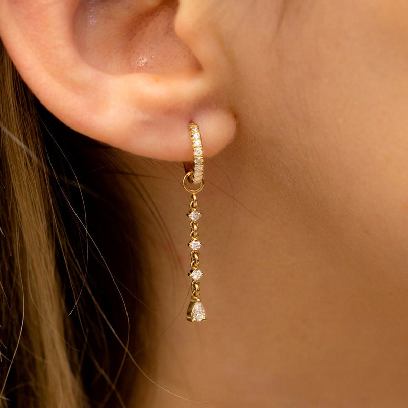 Model wears handmade gold diamond earring charms in 14k solid gold 