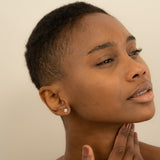 Model wears Dainty Diamond Flower Stud earring for her