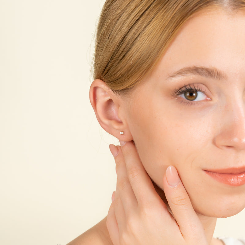 Model wears dainty Three Diamond Earring stud